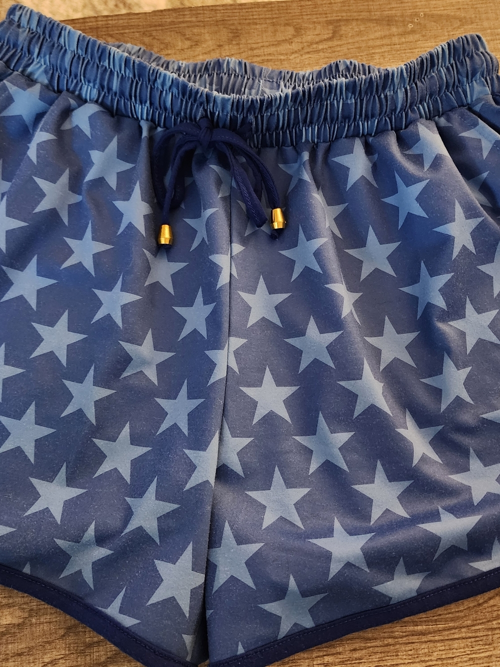 Blue Star Print Athletic Shorts With Front Pockets.